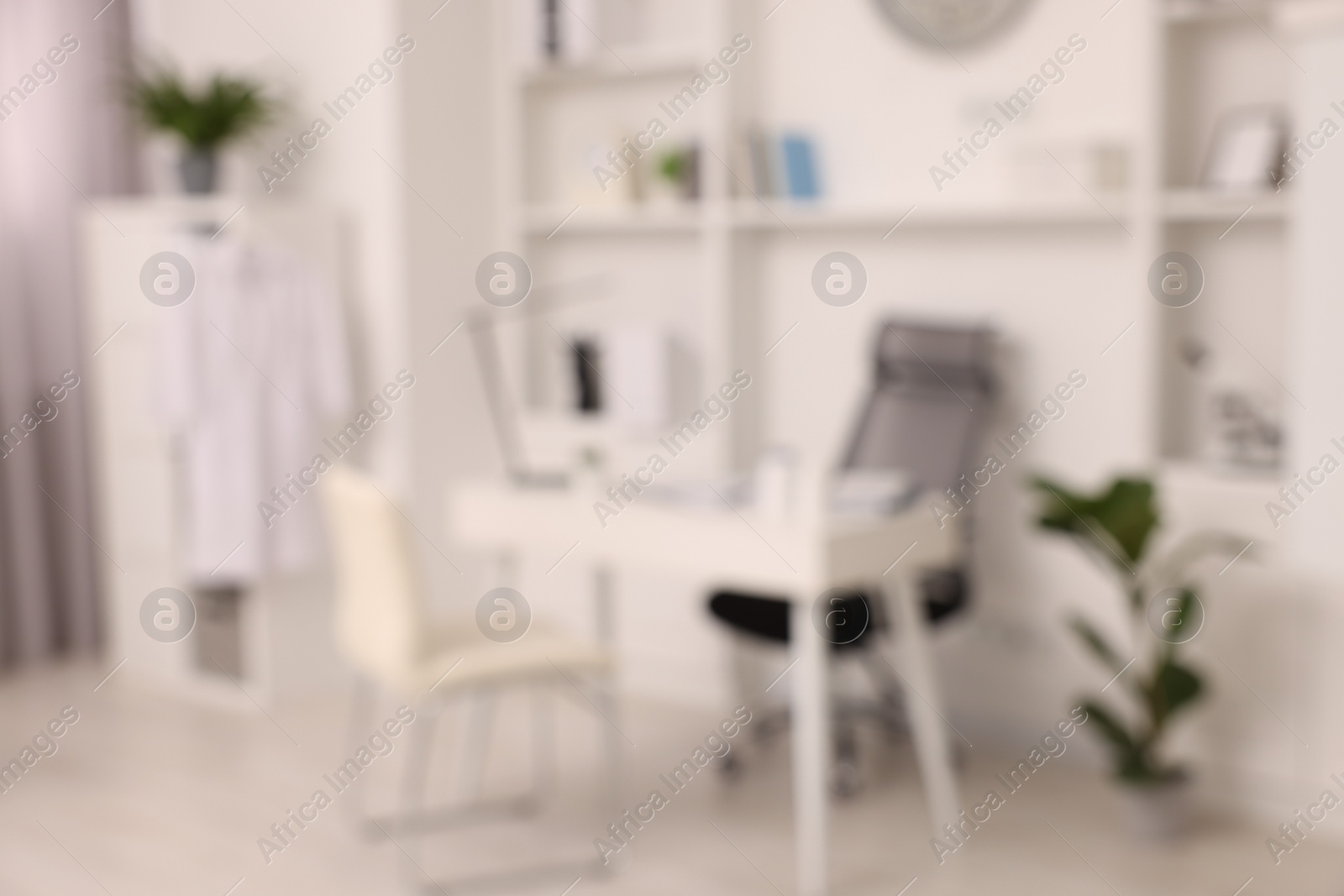 Photo of Blurred view of medical office interior with doctor's workplace