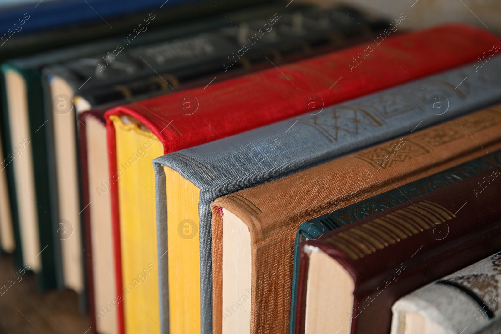 Photo of Stack of hardcover books on table, closeup