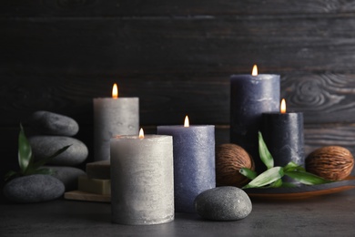 Spa composition with burning candles on table