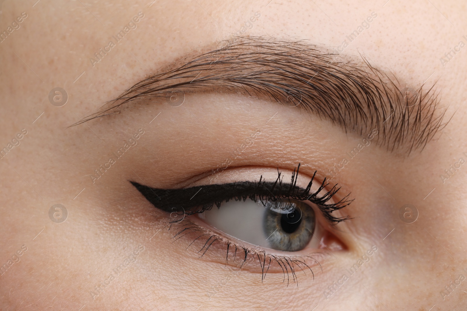 Photo of Makeup product. Woman with black eyeliner and beautiful eyebrow, closeup