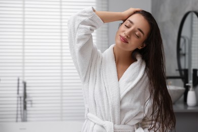 Photo of Beautiful young woman after shower in bathroom. Space for text