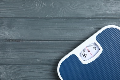 Photo of Scales on wooden background, top view with space for text. Weight loss