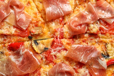 Photo of Delicious pizza with bacon as background, closeup