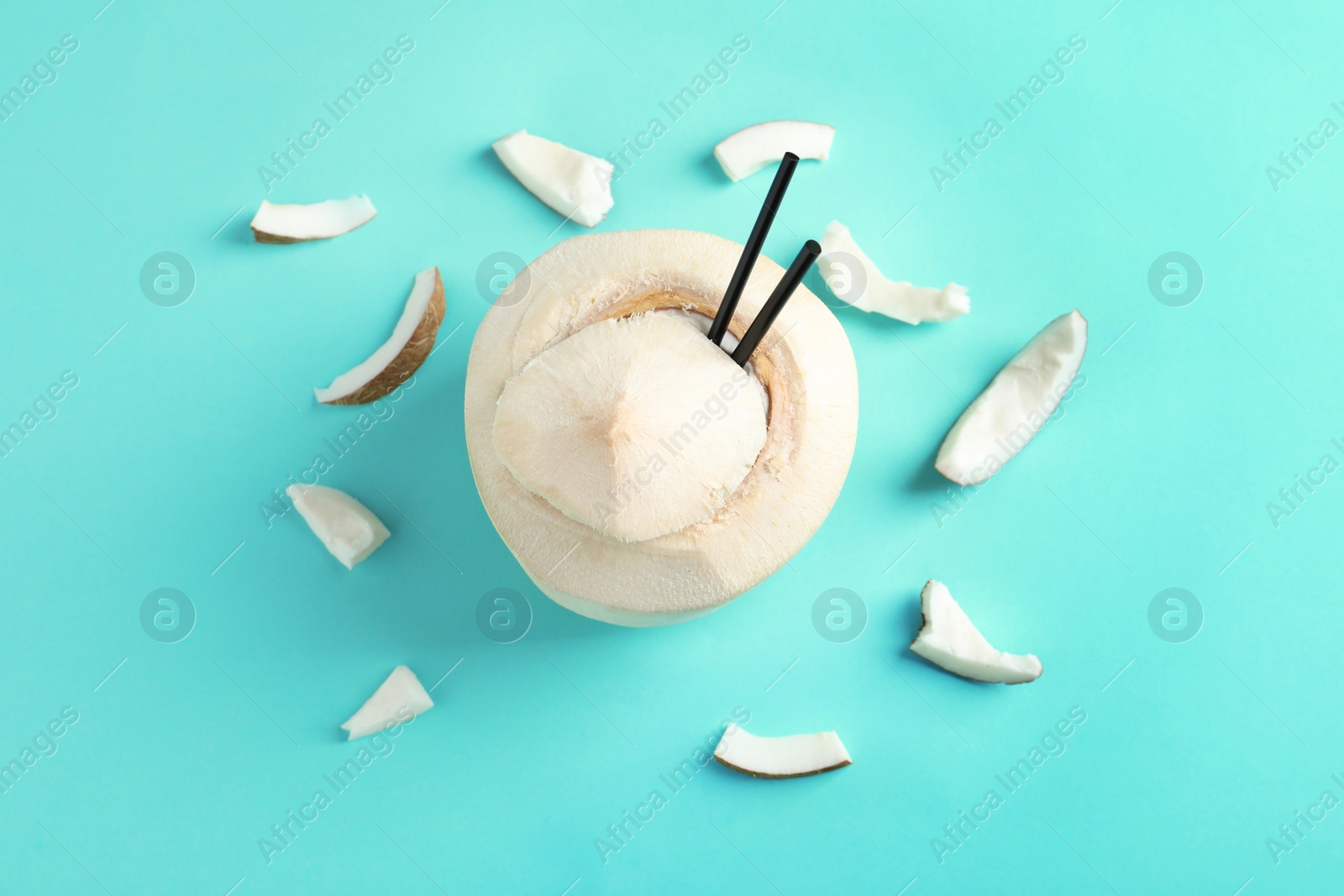 Photo of Fresh coconut drink in nut on color background