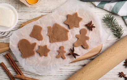 Photo of Making Christmas cookies. Flat lay composition with raw dough and ingredients on white wooden table