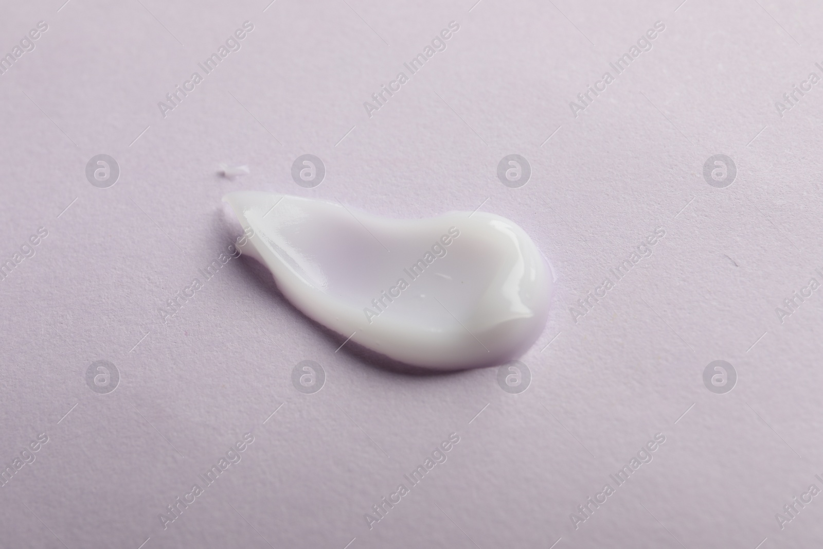 Photo of Sample of cream on pink surface, top view