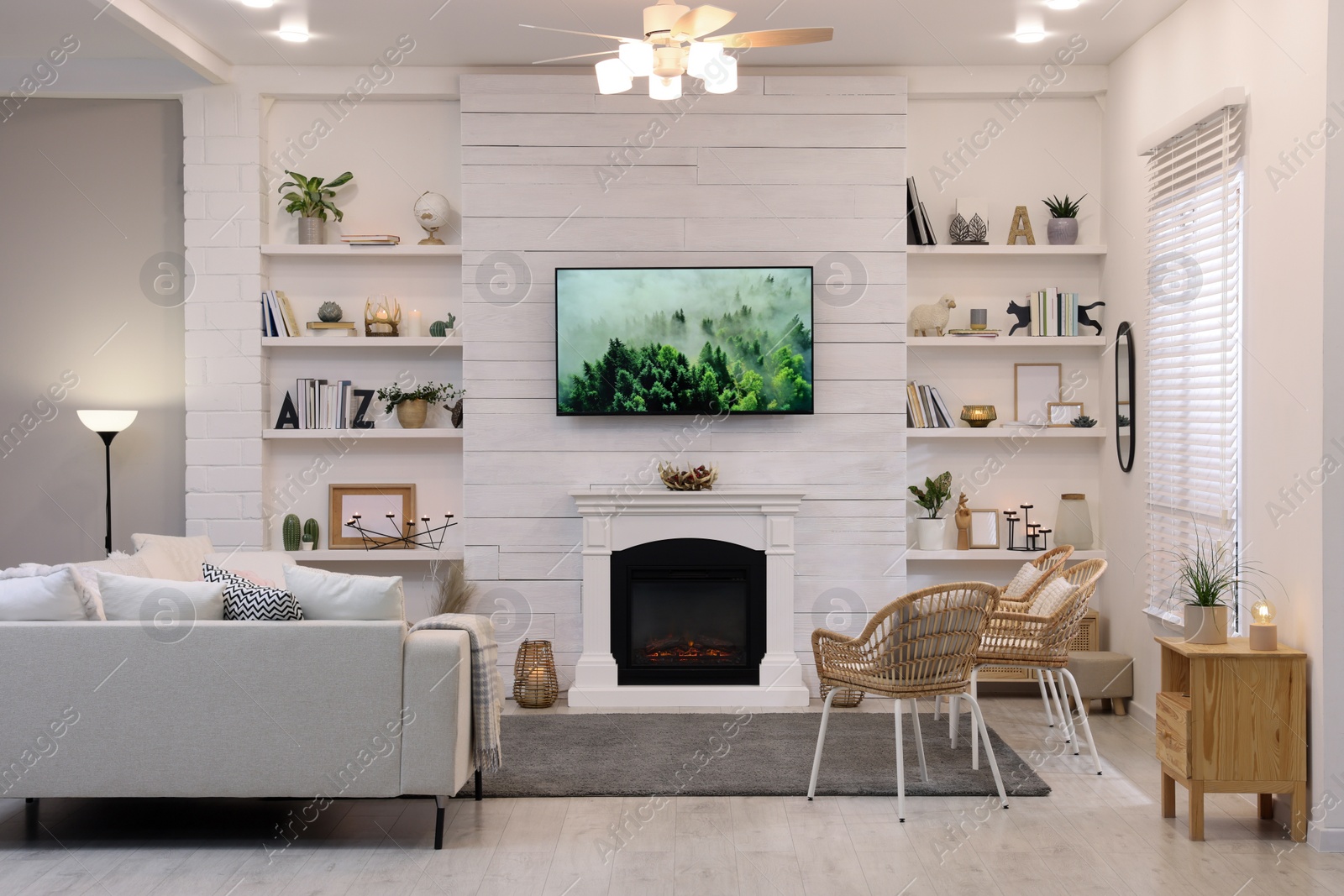 Photo of Cozy living room interior with comfortable sofa and decorative fireplace