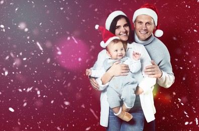 Image of Happy couple with cute baby wearing Santa hats on red background, space for text. Magical Christmas atmosphere