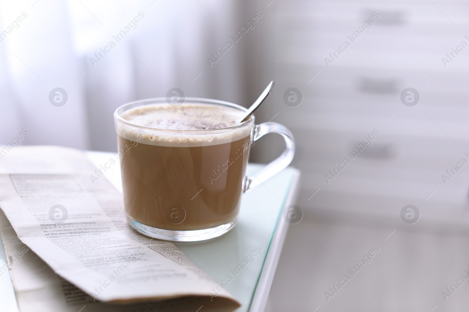 Photo of Morning coffee and newspaper on table indoors. Space for text