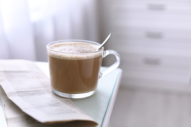 Morning coffee and newspaper on table indoors. Space for text