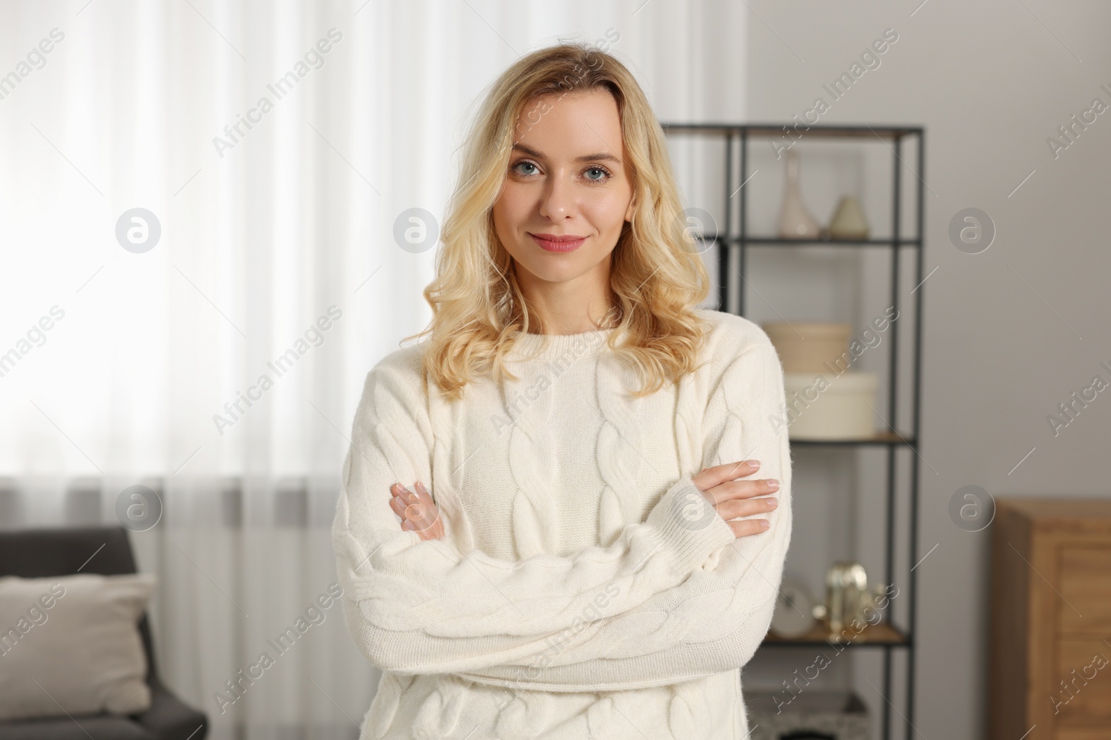 Photo of Beautiful woman in stylish warm sweater at home