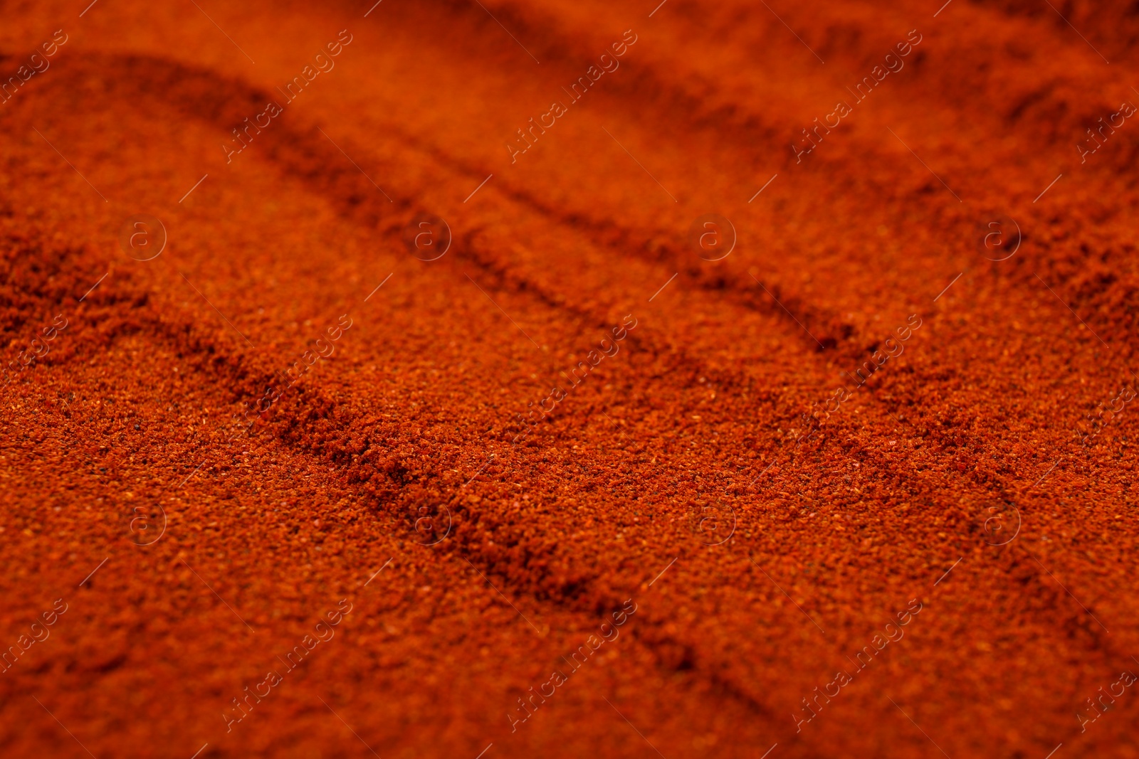 Photo of Aromatic paprika powder as background, closeup view