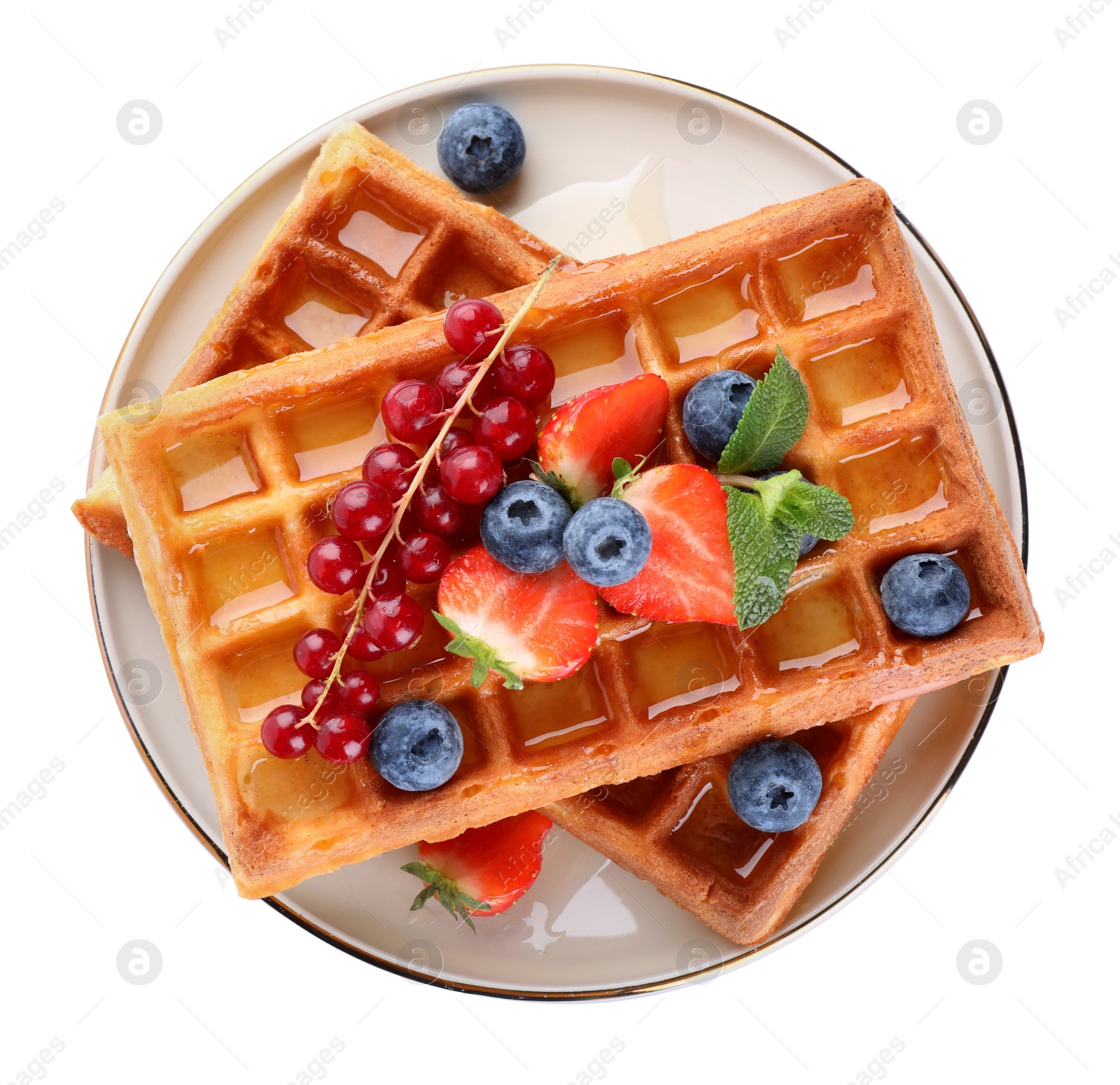 Photo of Delicious Belgian waffles with berries on white background, top view