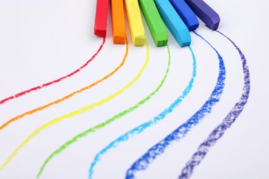 Colorful pastel chalks and lines on white background. Drawing materials