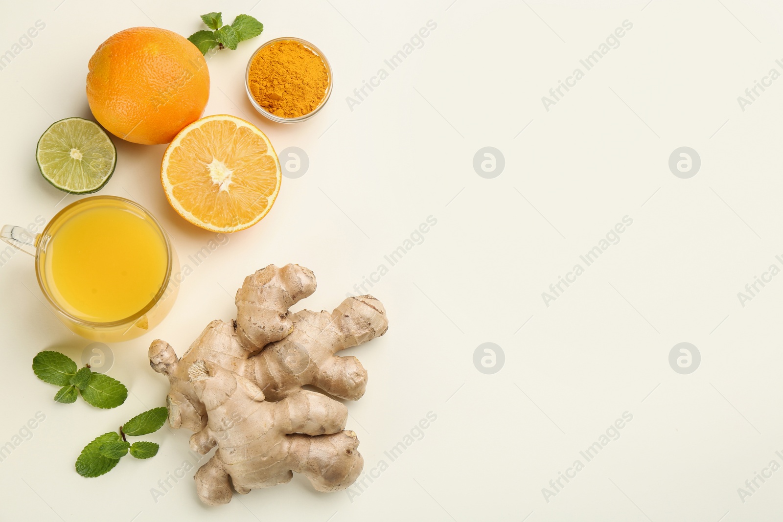 Photo of Immunity boosting drink and ingredients on white background, flat lay. Space for text