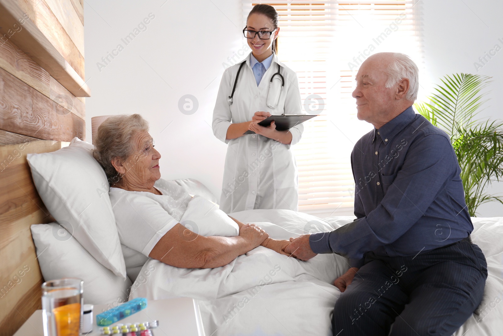 Photo of Senior couple and doctor in modern hospital