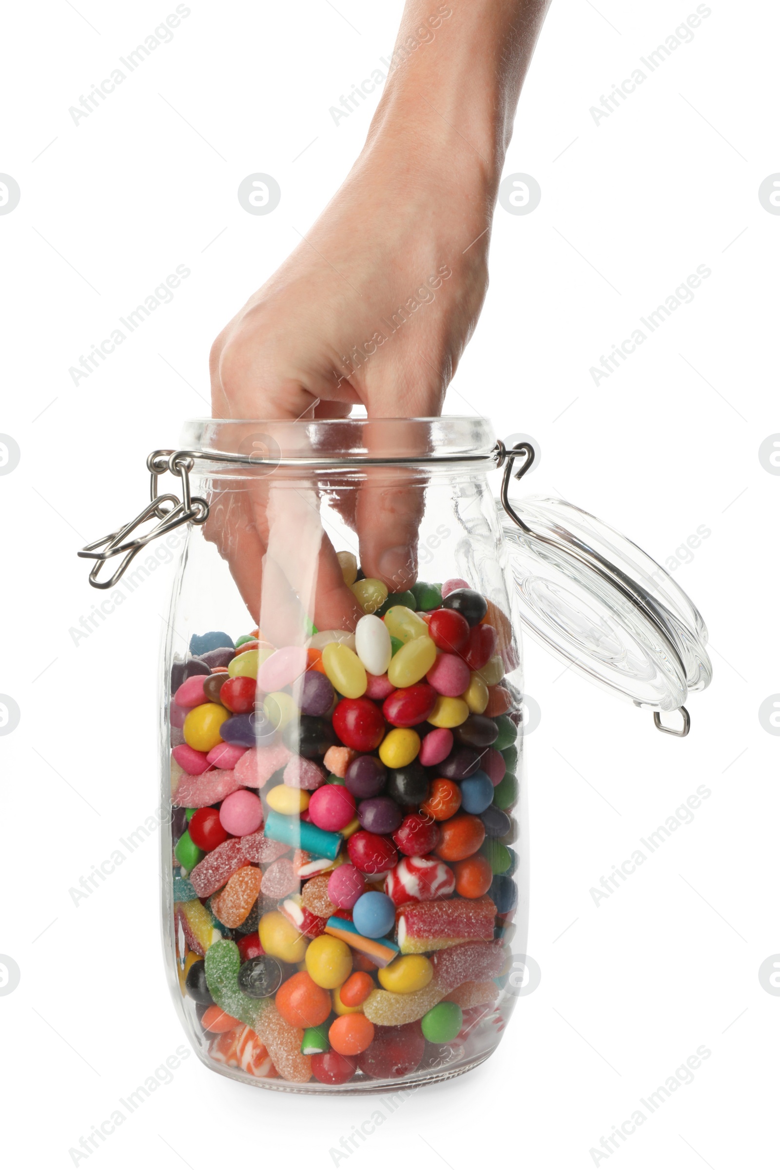 Photo of Woman taking candies from glass jar on white background, closeup