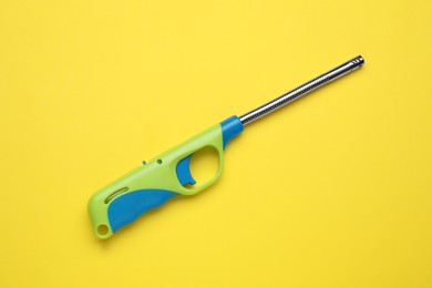 One gas lighter on yellow background, top view