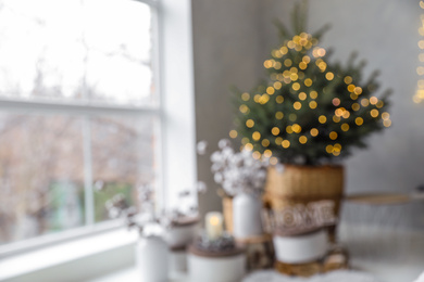 Blurred view of little Christmas tree in bedroom. Festive interior