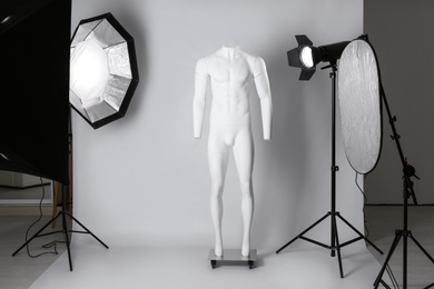 Photo of Ghost mannequin and professional lighting equipment in modern photo studio