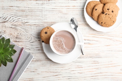 Flat lay composition with hot cocoa drink and cookies on wooden background