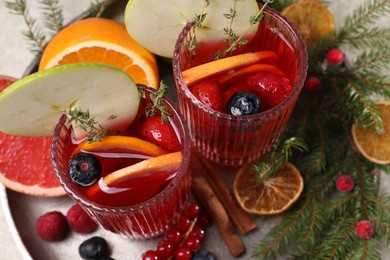 Photo of Aromatic Christmas Sangria in glasses served on table, above view