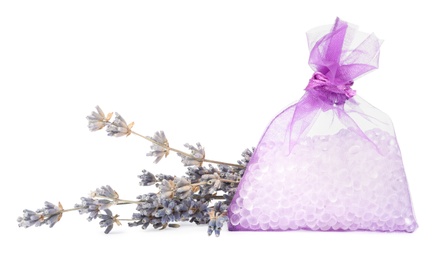 Scented sachet with aroma beads and dried lavender on white background