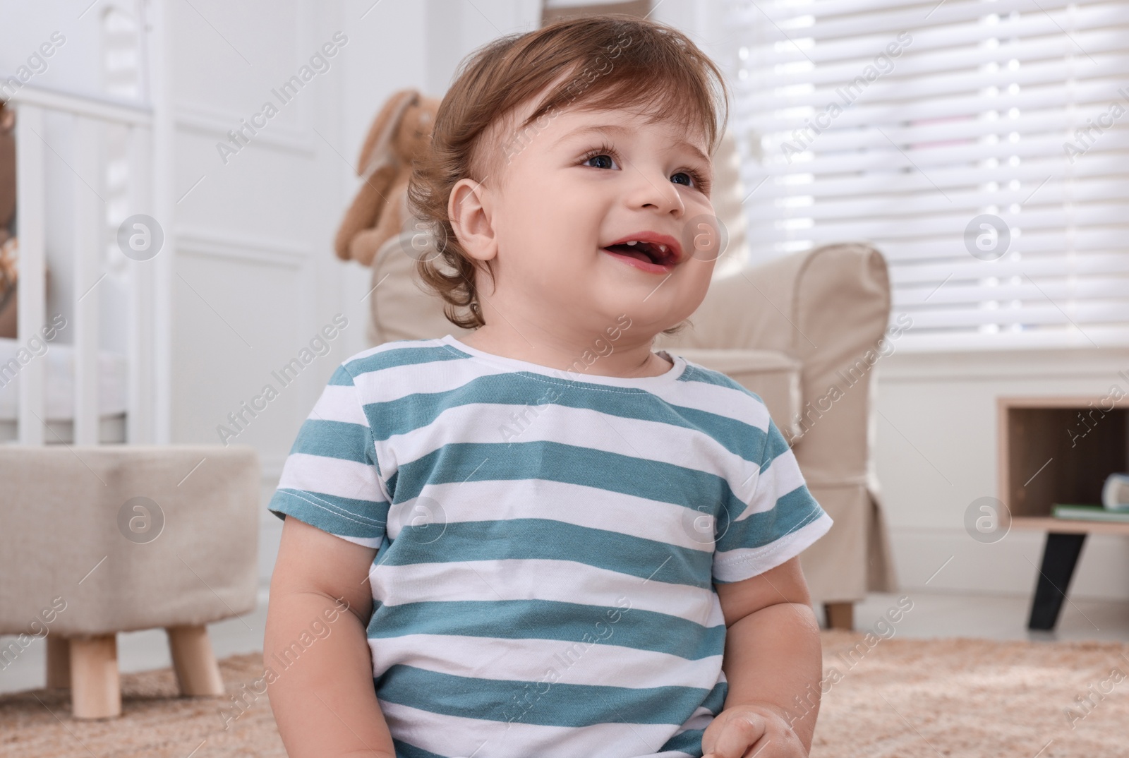 Photo of Cute little boy in room at home. Adorable child