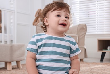 Photo of Cute little boy in room at home. Adorable child