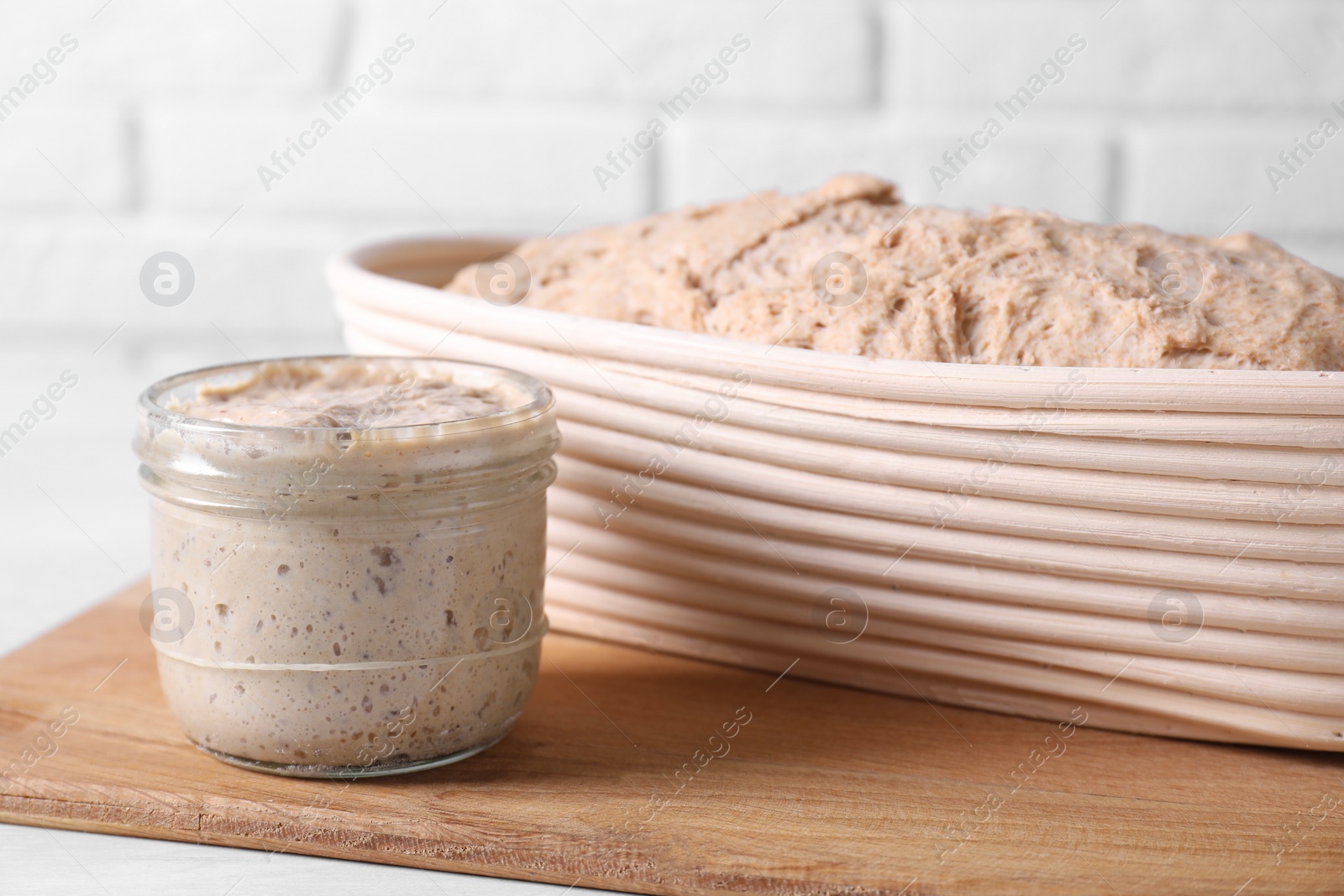 Photo of Fresh sourdough starter and dough on table