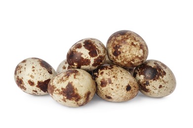Photo of Many speckled quail eggs on white background