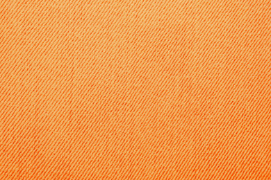 Texture of orange jeans as background, closeup
