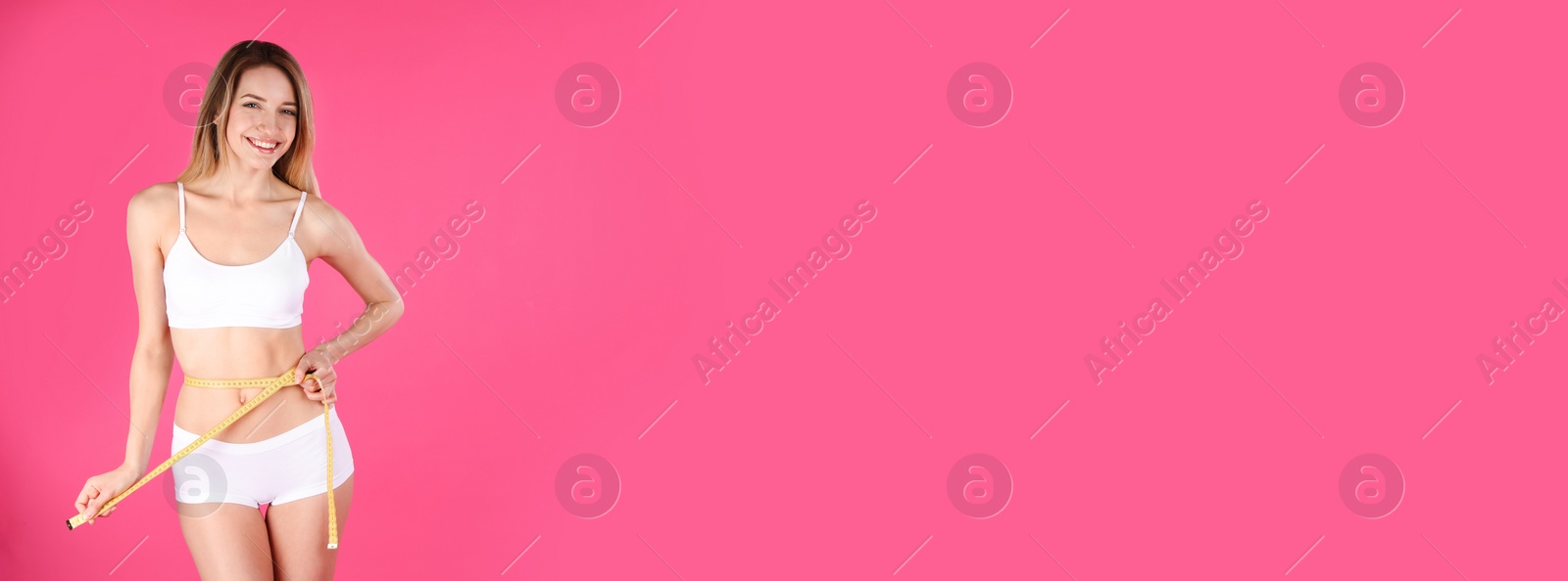 Image of Slim woman measuring her waist on pink background, space for text. Banner design