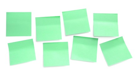 Blank pale yellow sticky notes on white background, top view. Space for text