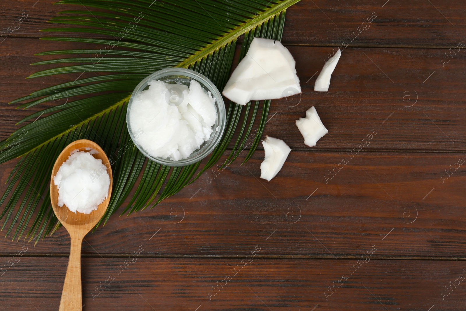 Photo of Flat lay composition with organic coconut oil on wooden table. Healthy cooking