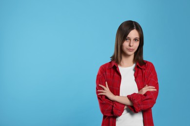 Photo of Portrait of teenage girl on light blue background. Space for text