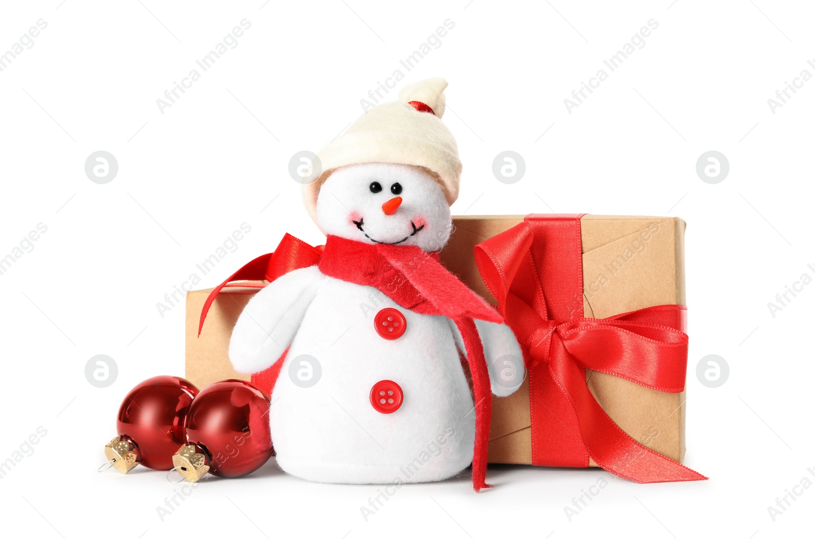 Photo of Cute snowman toy, gift boxes and red Christmas balls isolated on white