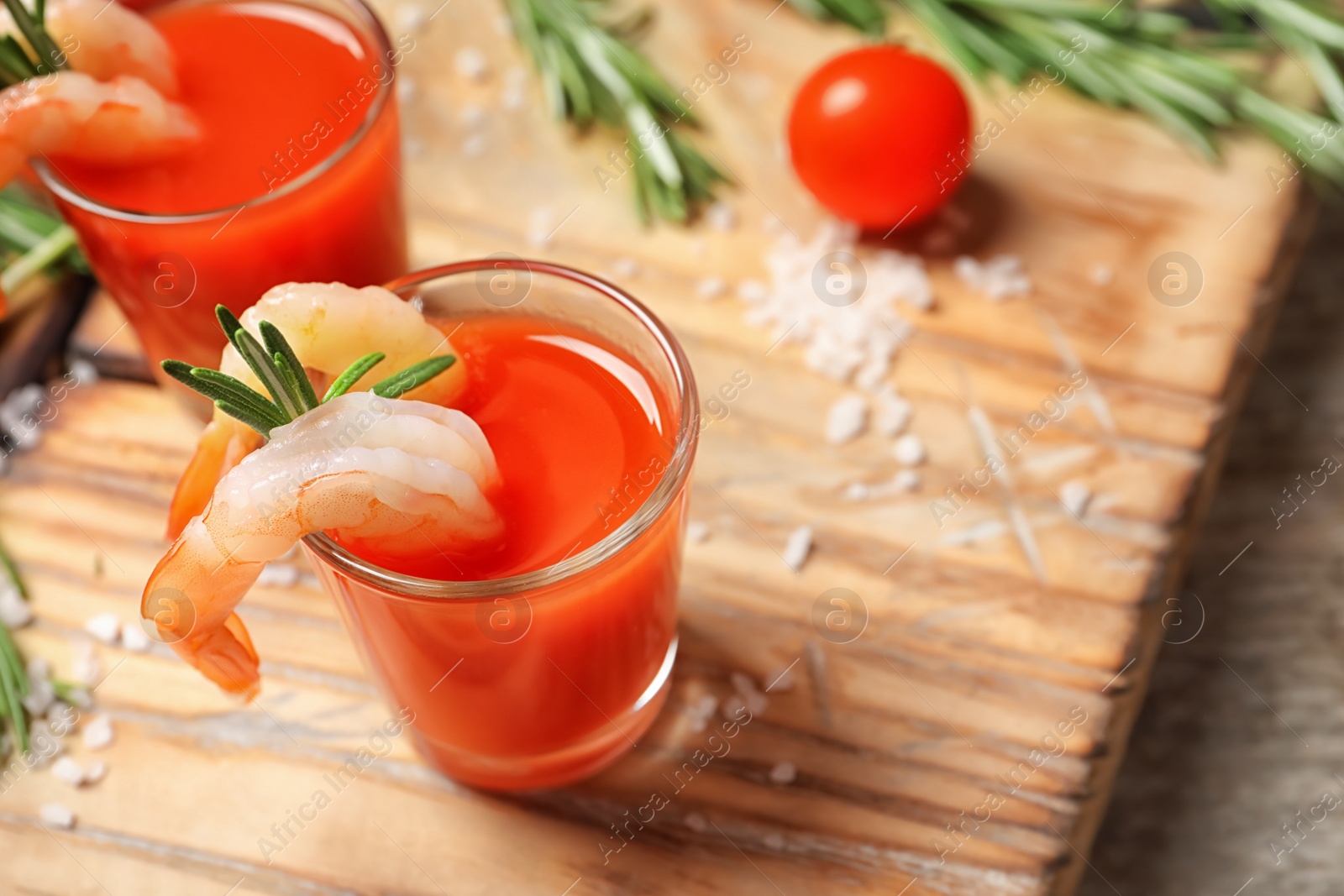 Photo of Delicious shrimp cocktail shots on wooden table