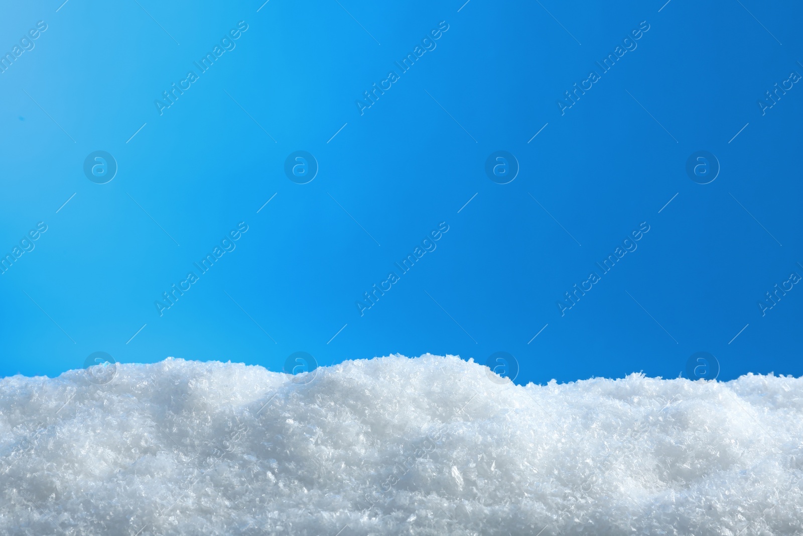 Photo of White snow drift on blue background. Winter weather