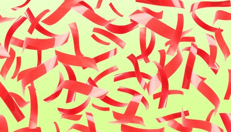 Image of Bright red confetti falling on yellowish green background. Banner design