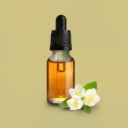 Image of Bottle of jasmine essential oil and flowers on dark beige background