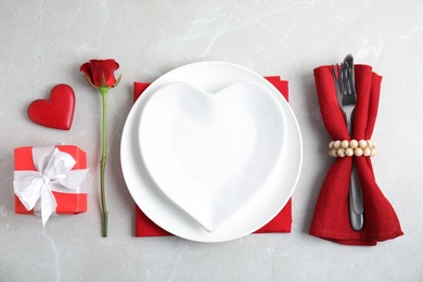 Photo of Beautiful table setting for romantic dinner on light grey background, flat lay. Valentine's day celebration