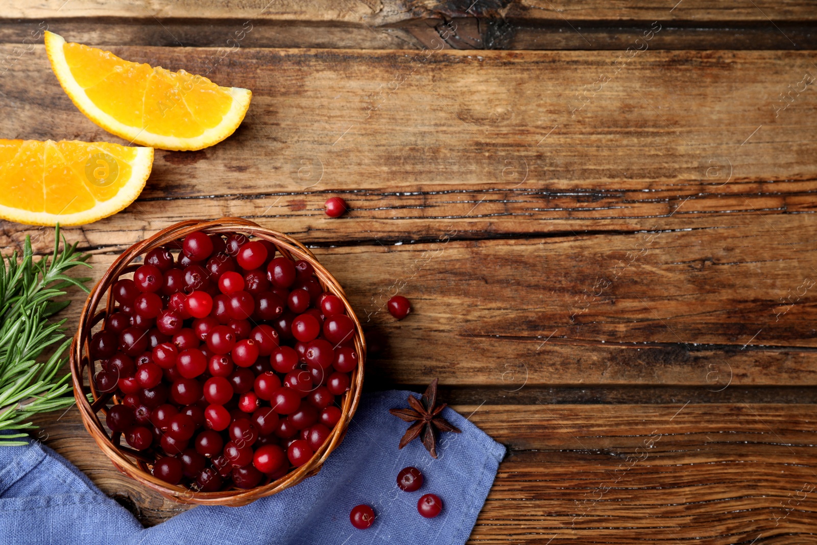 Photo of Flat lay composition with fresh ripe cranberries on wooden table. Space for text