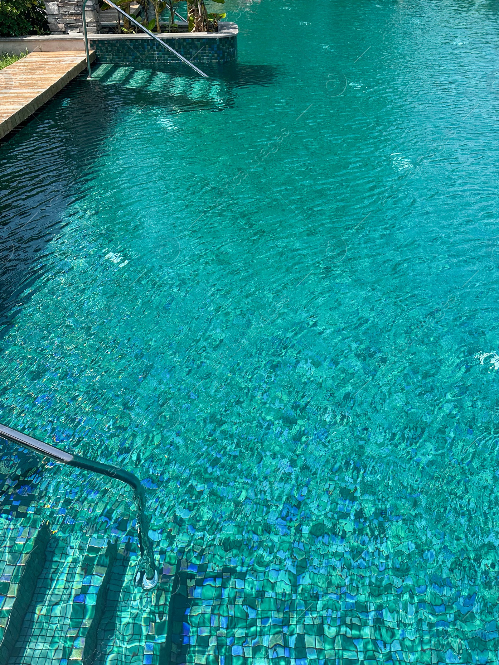 Photo of Metal rail and steps in outdoor swimming pool