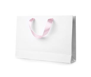 Photo of Paper shopping bag with ribbon handles on white background. Mockup for design