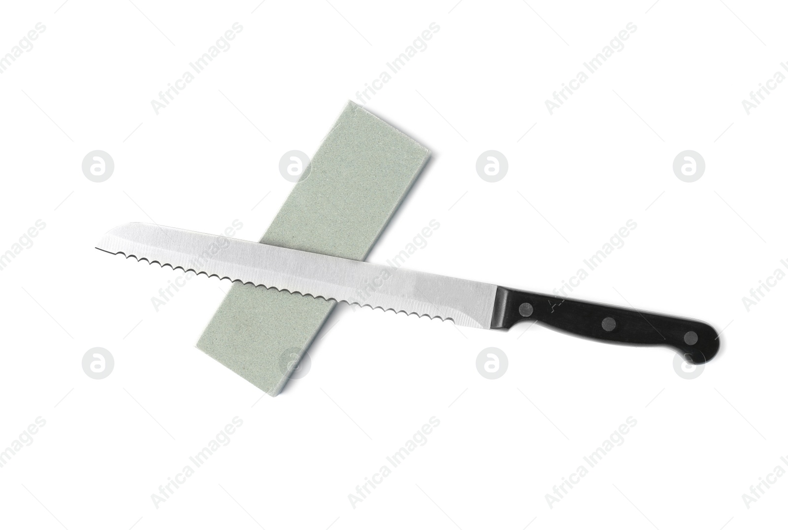 Photo of Bread knife and grindstone isolated on white, top view