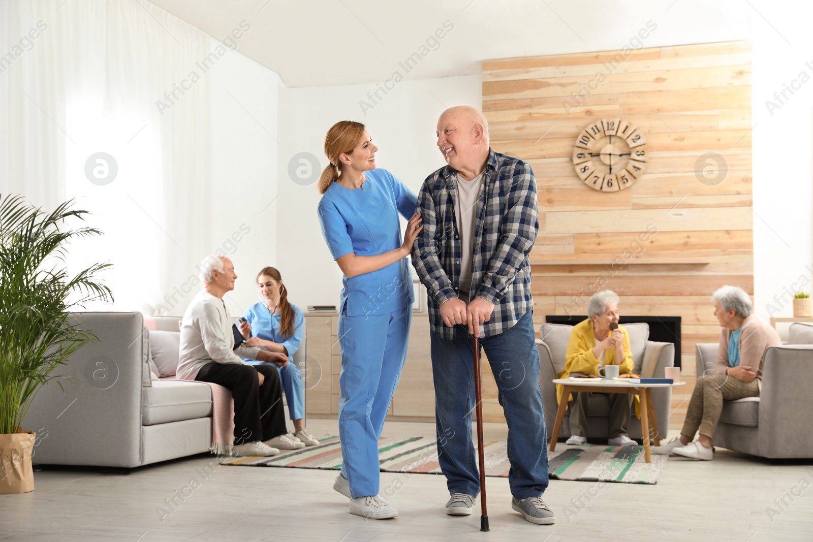 Photo of Nurses assisting elderly people at retirement home