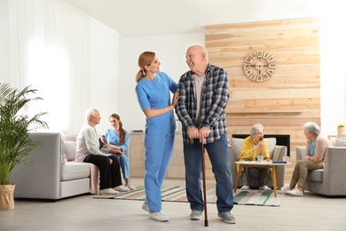 Nurses assisting elderly people at retirement home