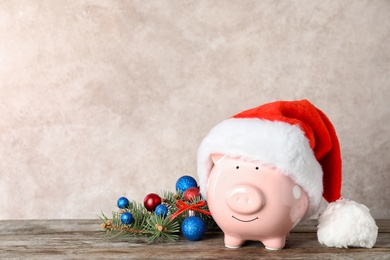 Composition with piggy bank and Christmas decor on table. Space for text