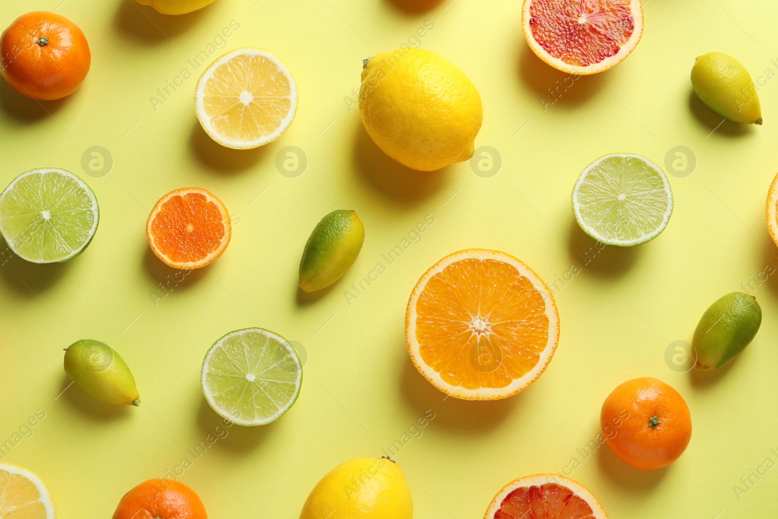 Photo of Different citrus fruits on color background, flat lay